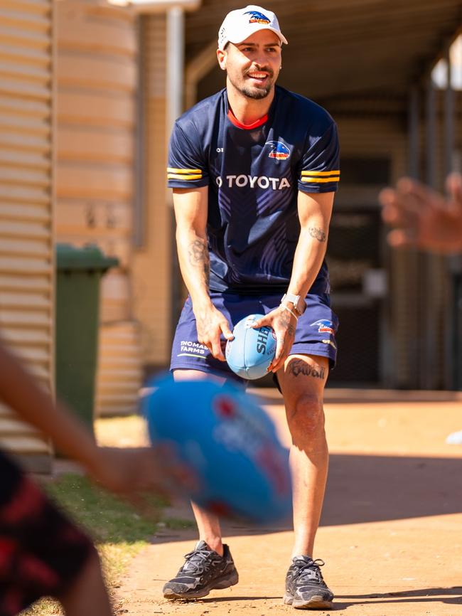 Izak Rankine playing footy in the APY Lands. Picture: AFC