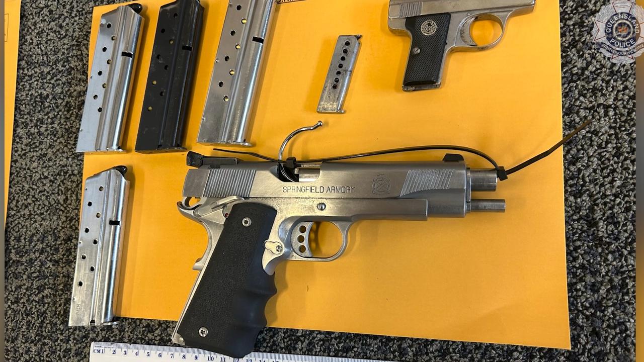 Two guns were allegedly found by police hidden inside a cut-out in a wall at a Maryborough property.