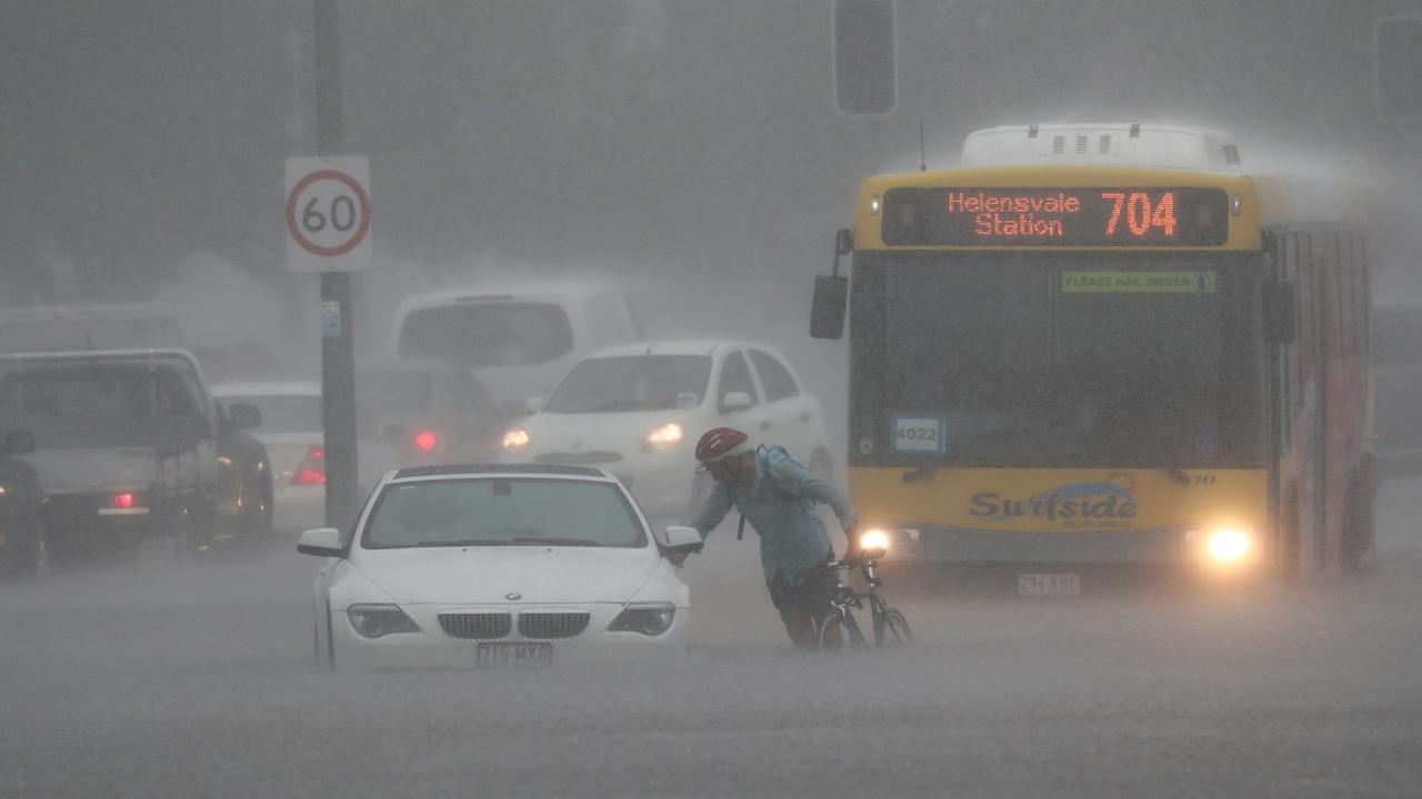 A car is flooded on Queen St in Southport after a storm lashes the Gold Coast. Photograph : Jason O’Brien