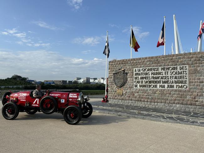 Warren Brown parks the Bean 14 roadster outside the Dunkirk war memorial in France en route to Austria via Germany.