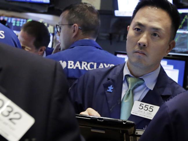 Trader John Song works on the floor of the New York Stock Exchange, Thursday, Aug. 13, 2015. Global stocks are steadying as the decline in China's currency slowed and the country's central bank tried to ease fears of more big declines. (AP Photo/Richard Drew)