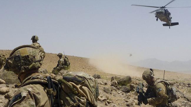 Australian Army soldiers prepare to be extracted by a US Army Black Hawk helicopter in Afghanistan.