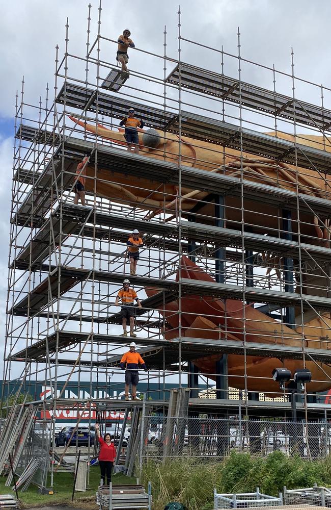 Ballina Mayor Sharon Cadwallader standing below the Big Prawn and the workers restoring the gargantuan crustacean. Picture: Supplied