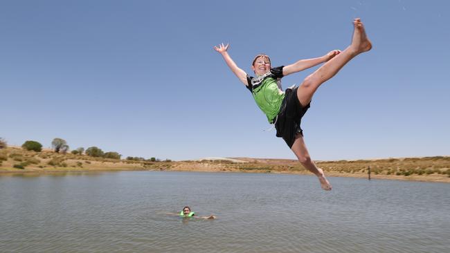 William Franklin, 11, and friend Jake Penhall, 10, at Blue Dam on the outskirts of Andamooka. Picture: Tait Schmaal