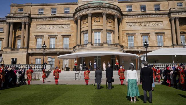 King Charles III and Camilla, Queen Consort arrive to meet the guests attending the Garden Party at Buckingham Palace, in London, on Wednesday. Picture: AFP