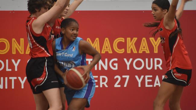 Leah Pearson for the Cairns Dolphins is surrounded by Samantha Padget, Cheyenne Bobongie and Isabel Smith in the U14 State Championship final in Mackay, July 10, 2021. Picture: Matthew Forrest