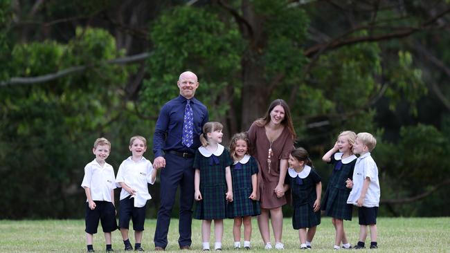 Coast Christian School Principal Matthew Drennan pictured Thursday 17th March 2022 with Kindergarten teacher Georgina Battle who also taught in Kindy many years ago and kindy kids Tyler King,Oliver Lendrum,Lola Robertson,Vivienne CarneyClementine Stucken,Lilly Jones and Morgan Smith .pic Sue Graham