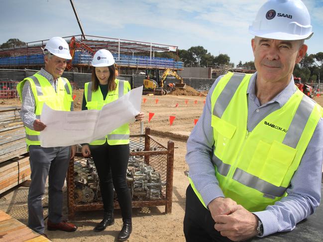 Defence and engineering firm Saab Australia, is constructing a new facility and growth pipeline. Managing director Andy Keough (F), with Head of Autonomous Systems, SAAB Australia, Rebecca Brickhill, and Dave Symonds, General Manager of the Maritime division of SAAB Australia, at the Mawson Lakes construction site. 18 September, 2023. Picture Dean Martin