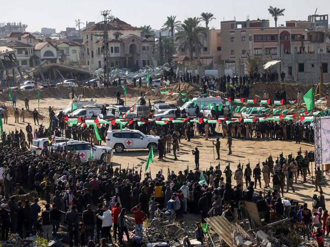 TOPSHOT - Red Cross vehicles wait at the spot where Hamas militants are expected to hand over Israeli hostages in Khan Yunis in the southern Gaza Strip on February 15, 2025, as part of the hostage-prisoner exchange. Gaza militants are due to release three Israeli hostages on February 15 in exchange for 369 Palestinians in Israeli custody, the sixth swap of a truce that came close to collapse this week. (Photo by Bashar TALEB / AFP)