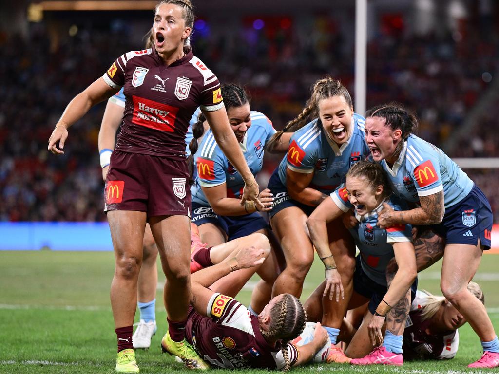 Abbi Church of the Blues celebrates with teammates after scoring a try during game one of the Women's State of Origin series. Picture: Getty Images