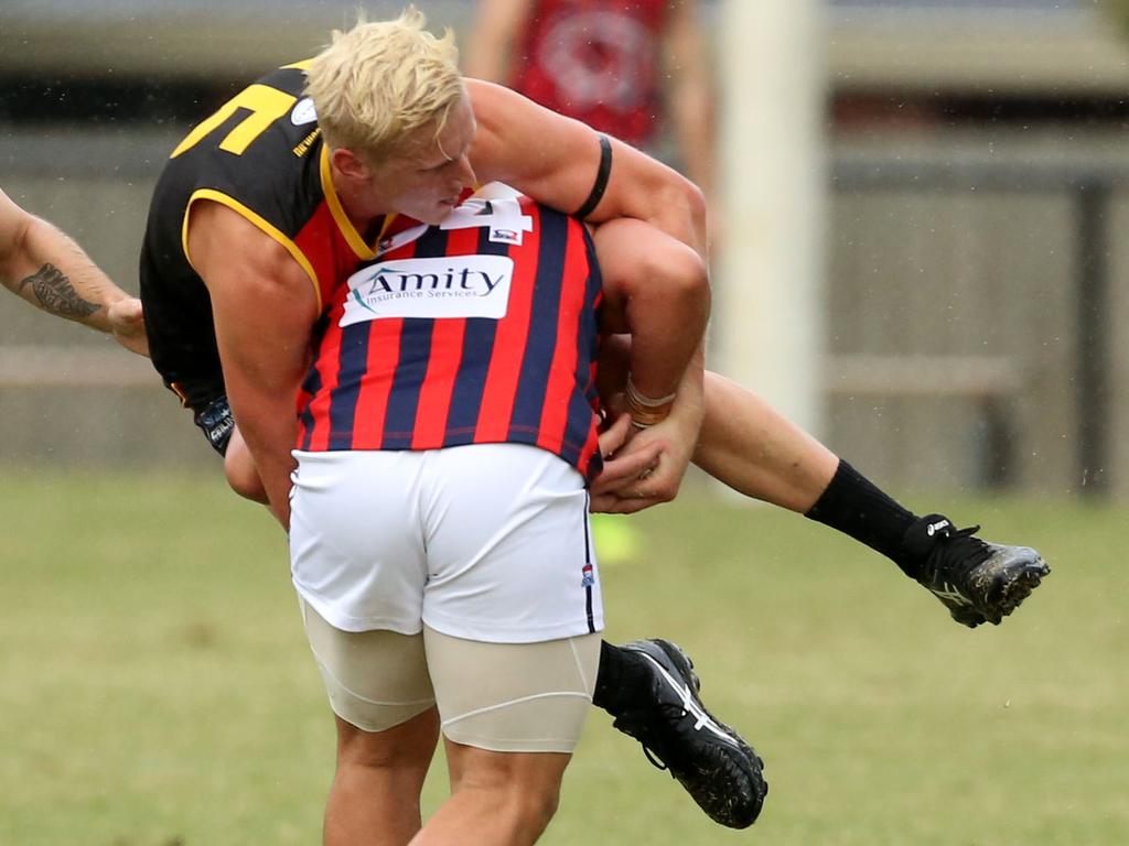 Southern: Dingley’s Kristen Feehan goes for a ride on East Malvern’s David Ismail. Picture: Stuart Milligan