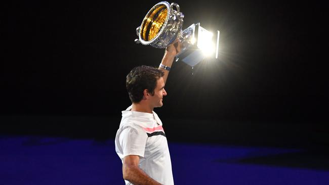 Switzerland's Roger Federer holds the Australian Open winner's trophy.