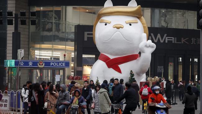 In this Friday Dec. 29, 2017, photo, a 22-foot dog sculpture with features widely perceived in China to resemble U.S. President Donald Trump is erected outside a shopping mall to celebrate the upcoming "Year of the Dog" in the Chinese zodiac in Taiyuan in northern China's Shanxi province. (Chinatopix Via AP)