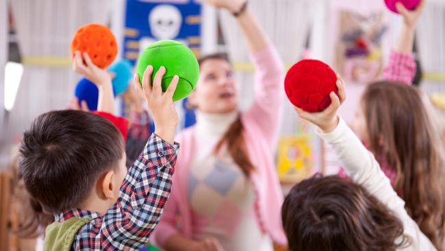 A childcare teacher with her class. Picture: iStock