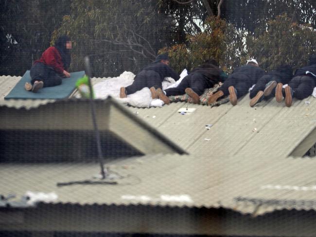 Inmates from the Frank Baxter Juvenile corrections centre Kariong taunt police from the roofs of various buildings. Some are armed with poles tennis rackets ect. Picture: John Grainger