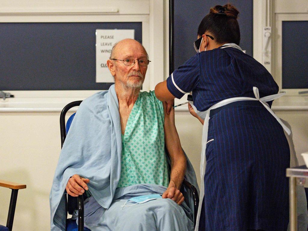 A nurse administers the Pfizer-BioNtech COVID-19 vaccine to patient William "Bill" Shakespeare (L), 81, in central England on December 8, 2020. Picture: Jacob King/Pool/AFP