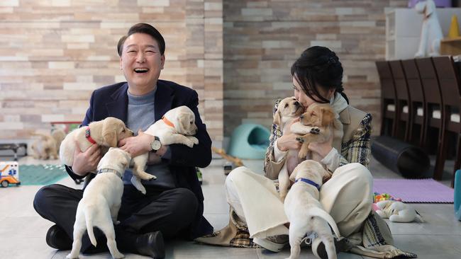 South Korean President Yoon Suk Yeol and first lady Kim Keon Hee pose with puppies in Yongin. Picture: AFP.