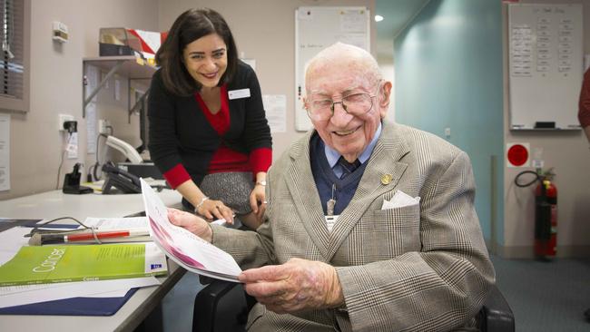 The Liverpool Hospital staff library team wear red on a Monday so legally blind volunteer Alwyn Bridge knows where they are at all times. Picture: Melvyn Knipe