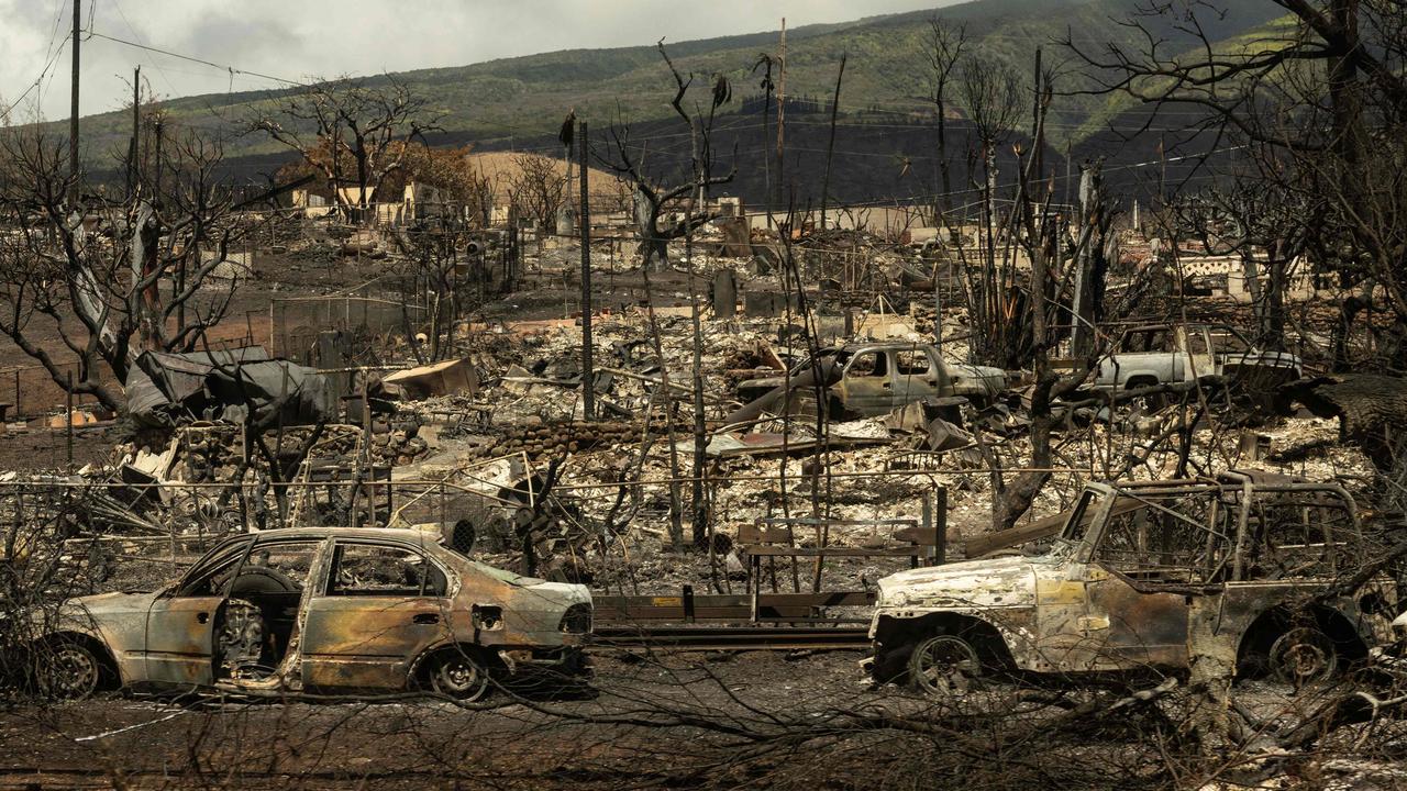 Carcasses of cars can be seen among the ashes of a burnt neighborhood in the aftermath of a wildfire in Lahaina, western Maui, Hawaii on August 14, 2023. The death toll could double over the next 10 day. Photo: Yuki IWAMURA / AFP.