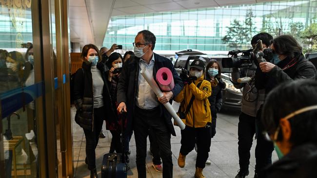 WHO’s Peter Ben Embarek and other members of the group arrive at Tianhe International Airport to leave Wuhan in China's central Hubei province on February 10 after twrapping up its investigation into the origins of COVID-19. Picture: AFP