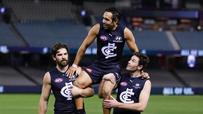 Carlton teammates Levi Casboult (left) and Mitch McGovern (right) chair Eddie Betts off the ground after his last match. Picture: Getty