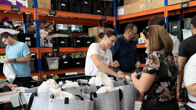 Volunteers now help Malan pack hundreds of bags, which are distributed to those most in need. Picture: Ana Koch