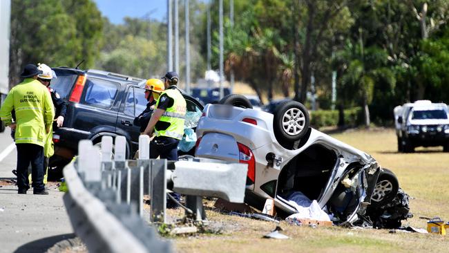 Emergency services attend a fatal crash involving three vehicles just north of the Yabulu Overpass. Picture: Alix Sweeney