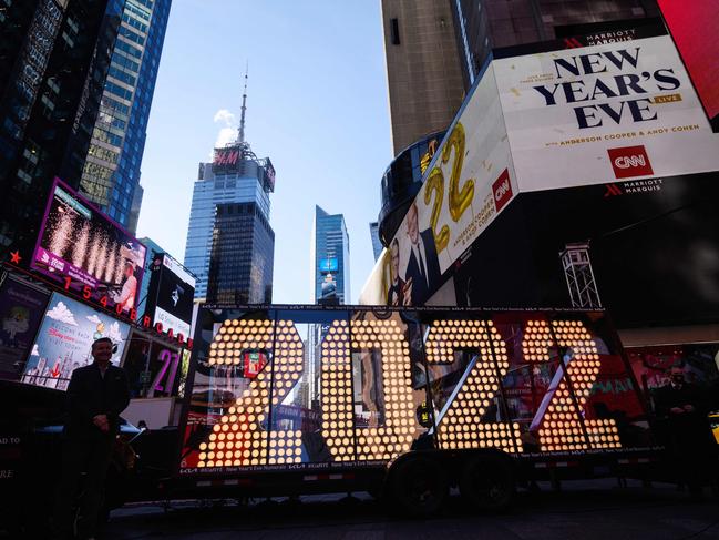 People pose for photos before the 2022 numerals to be used at a new year countdown event in Times Square in New York, on December 20, 2021. Picture: Ed Jones / AFP