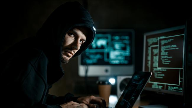 Hacker working on computer. Cyber crime concept. Scam, scammer generic.