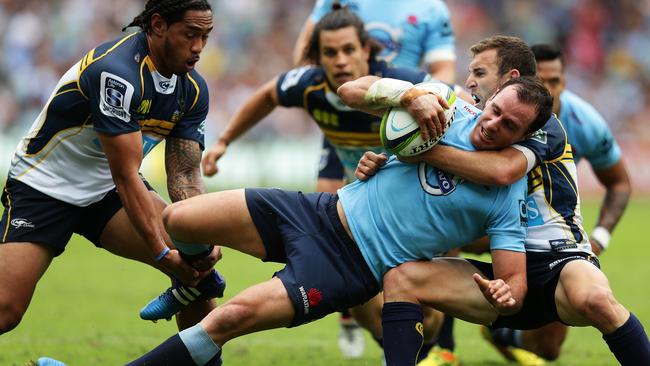 Matt Carraro is brought down by the Brumbies defence.