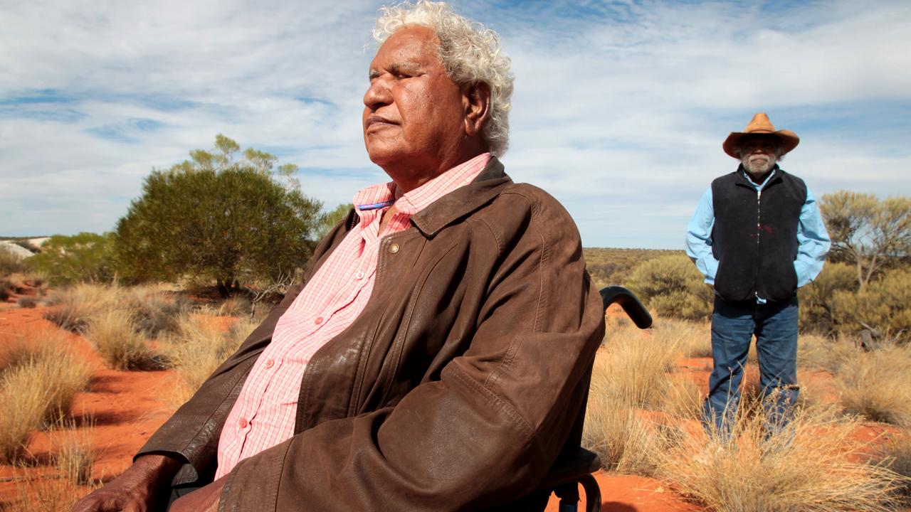 Yami Lester, in wheelchair, the traditional owner of Wallatina Station in the far north of South Australia and Mike Williams from Mimili. Picture: Kelly Barnes