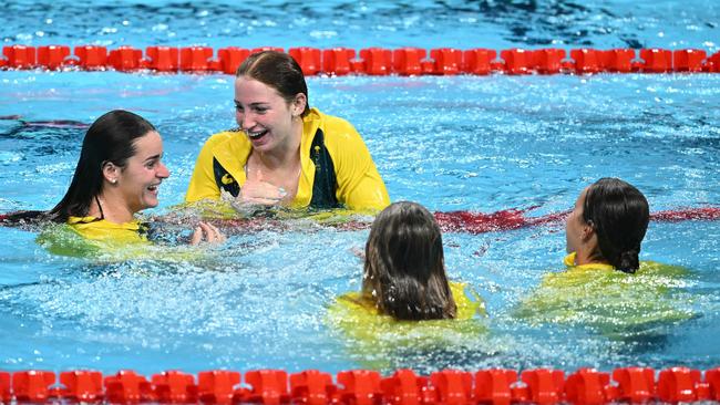 Aussie female swimmers dive in the pool at the end of the medley relay presentation ceremony. PIcture: Sebastien Bozon/AFP