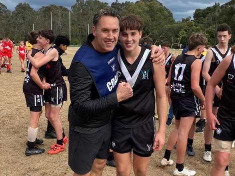 Anthony Koutoufides with son Lukas who was best on ground in the under 14s grand final.