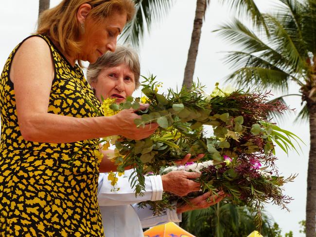 Townsville mayor Jenny Hill, left, and Doreen Callanan carry wreaths to the sea for Surf Life Saving memorial Day. Picture: Blair Jackson.