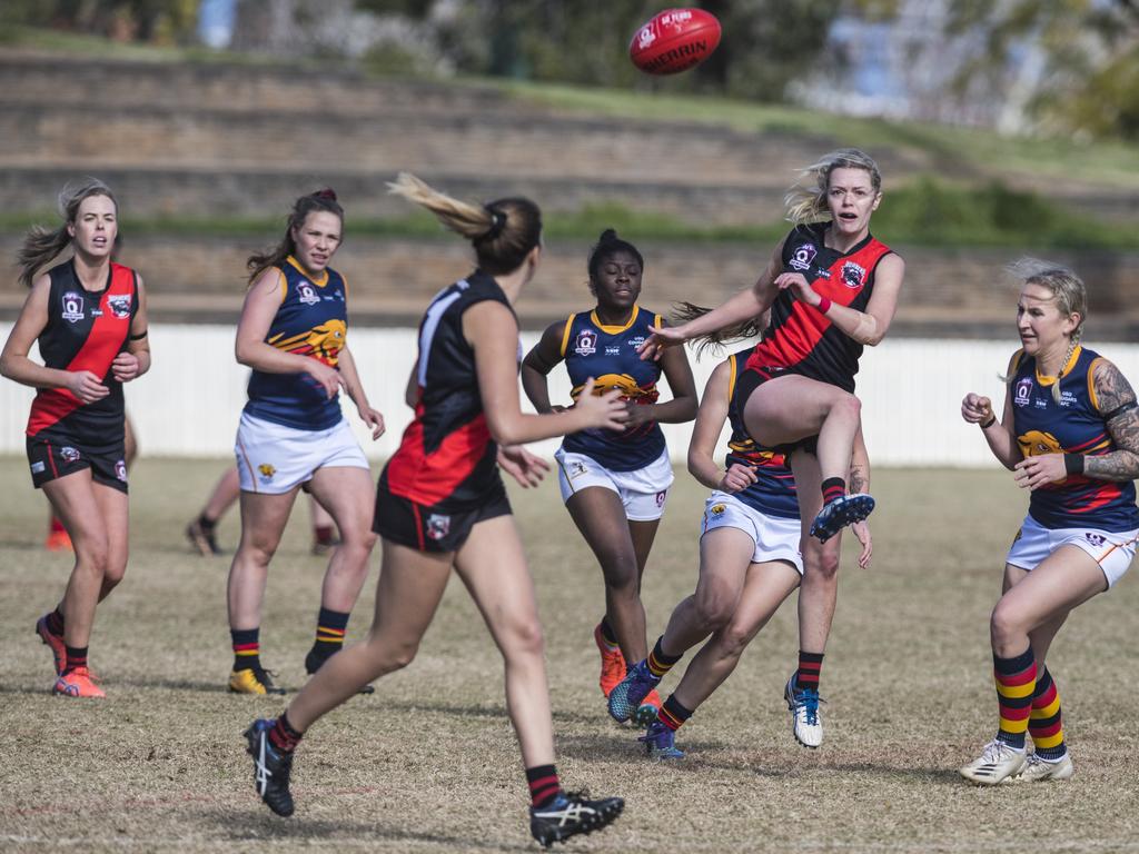 Stephanie Sanchez (centre) kicks for South Toowoomba against University in AFL Darling Downs senior women's round 9 at Heritage Oval, Saturday, June 19, 2021. Picture: Kevin Farmer