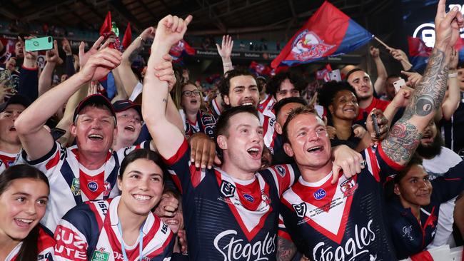 Luke Keary (L) and Jake Friend (R) celebrate victory with fans after the 2019 NRL grand final.