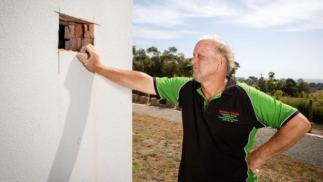 Terry Conder inspects a hole at his home. Picture: Mark Stewart