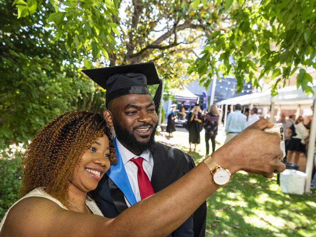 Bachelor of Nursing graduate Ghislain Mutamba celebrates with Labelle Mayangi at the UniSQ graduation ceremony at Empire Theatres, Wednesday, December 14, 2022.