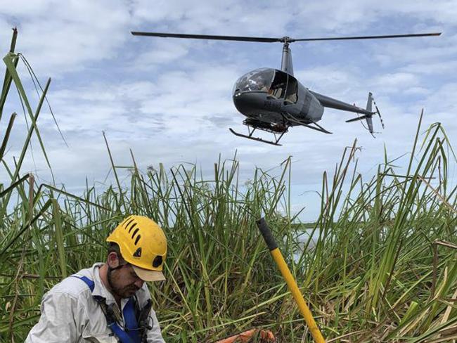 Remote Helicopters Australia director and chief pilot Michael Burbidge has been charged over the chopper crash that killed Outback Wrangler cast member Chris ‘Willow’ Wilson. Pictured here is Wilson in the foreground and behind him a chopper, piloted by Burbridge.