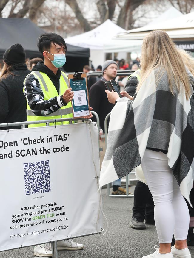 A Salamanca Market staff member prompts patrons to use the Check in TAS app. Picture: Nikki Davis-Jones