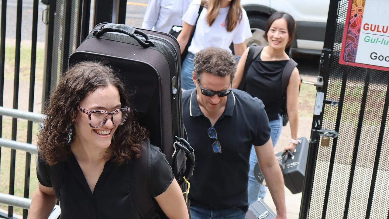 Nine Korbe (left) with other members of the Queensland Youth Orchestra delivering the instruments. Photo credit: Nina Korbe