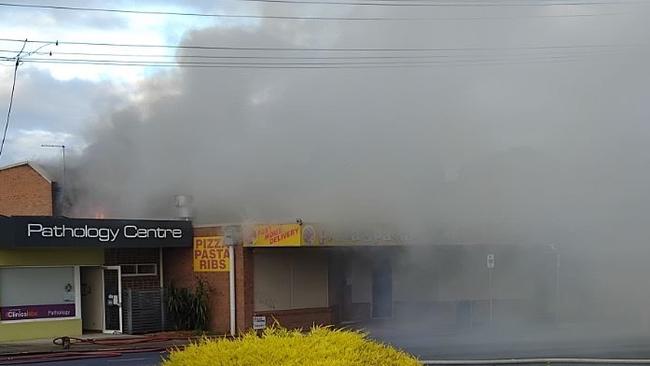 A large volume of smoke was seen coming out of the premises on Tuesday morning. Picture: Supplied