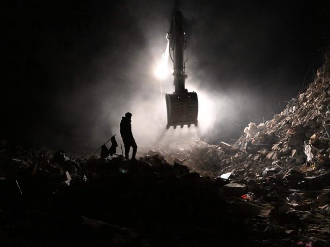 A local resident, whose loved ones are still under the rubble, wander near the collapsed buildings in Hatay. Picture: AFP