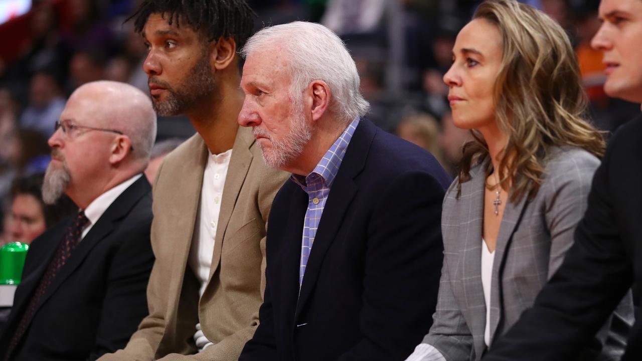 DETROIT, MICHIGAN - DECEMBER 01: Head coach Gregg Popovich of the San Antonio Spurs looks on next to assistant coaches Becky Hammon and Tim Duncan from the bench while playing the Detroit Pistons at Little Caesars Arena on December 01, 2019 in Detroit, Michigan. Detroit won the game 132-98. NOTE TO USER: User expressly acknowledges and agrees that, by downloading and or using this photograph, User is consenting to the terms and conditions of the Getty Images License Agreement. (Photo by Gregory Shamus/Getty Images)