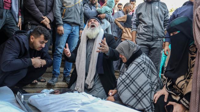 People mourn as they collect the bodies of Palestinians killed in an airstrike on  Khan Yunis, Gaza. Picture: Ahmad Hasaballah/Getty Images