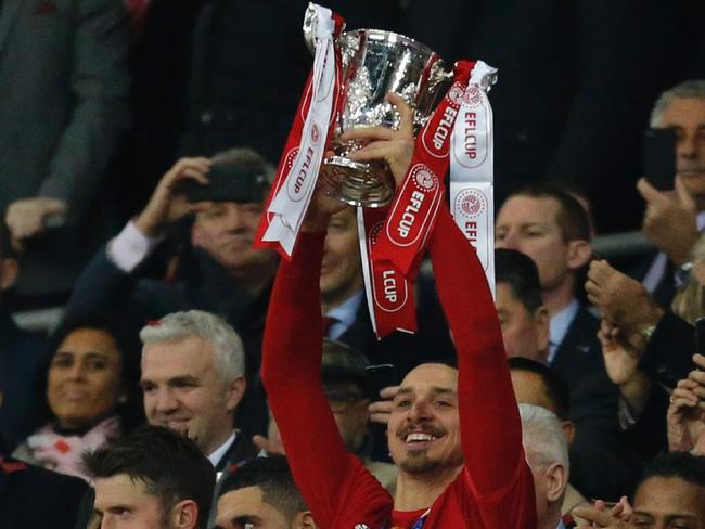 Man of the match, Manchester United's Swedish striker Zlatan Ibrahimovic lifts the trophy as Manchester United players celebrate their victory after the English League Cup final football match between Manchester United and Southampton at Wembley stadium in north London on February 26, 2017. Zlatan Ibrahimovic sealed the first major silverware of Jose Mourinho's Manchester United reign and broke Southampton's hearts as the Swedish star's late goal clinched a dramatic 3-2 victory in Sunday's League Cup final. / AFP PHOTO / Ian KINGTON / RESTRICTED TO EDITORIAL USE. No use with unauthorized audio, video, data, fixture lists, club/league logos or 'live' services. Online in-match use limited to 75 images, no video emulation. No use in betting, games or single club/league/player publications.  /