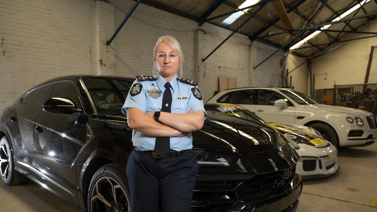 AFP Commander Paula Hudson with a Porsche, Lamborghini, and a Bentley. Picture: Jason Edwards