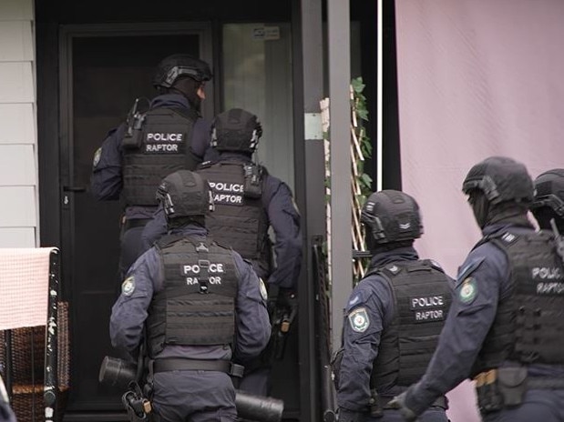 Police attend the home of a man who was arrested at Macquarie Fields as part of Strike Force Ashgill. Picture: NSW Police