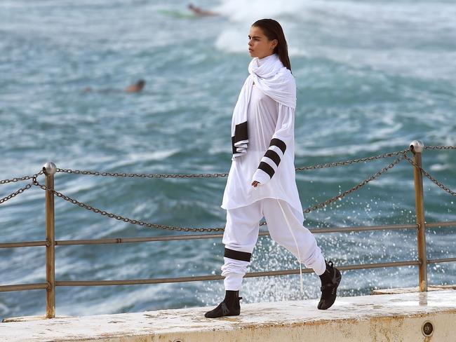 A model parades an outfit by fashion label Tenpieces at Bondi Beach during Fashion Week Australia in Sydney on April 16, 2015. AFP PHOTO / William WEST