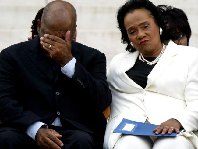 John Lewis is comforted by Coretta Scott King (R) after the unveiling of a commemorative granite engraving in honour of slain civil rights leader Dr. Martin Luther King, Jr in 2003. Picture: AFP